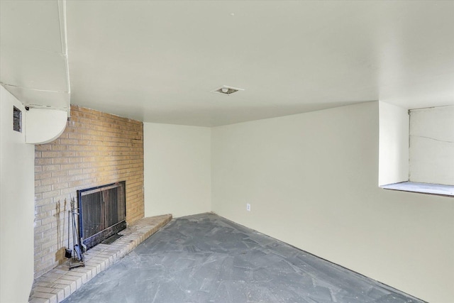 unfurnished living room featuring a fireplace and unfinished concrete floors