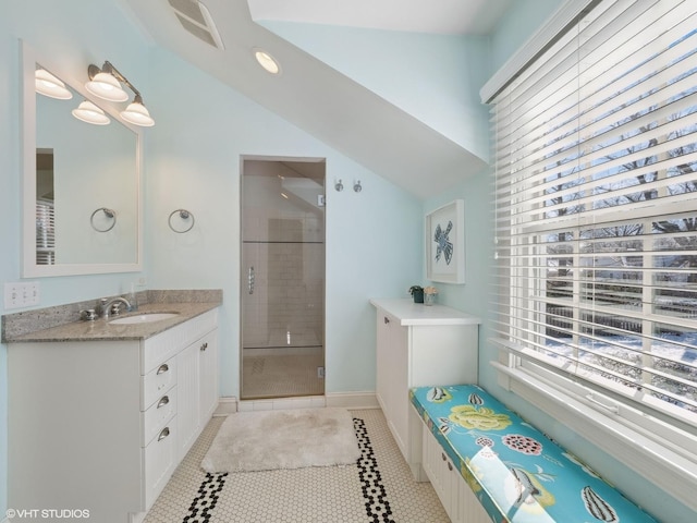 full bath with vanity, visible vents, lofted ceiling, a shower stall, and tile patterned floors