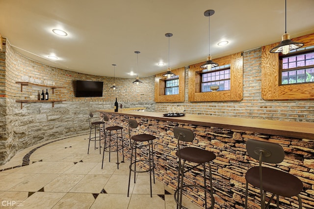 bar with wet bar, recessed lighting, and pendant lighting