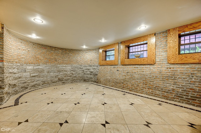 interior space with recessed lighting, brick wall, and tile patterned floors