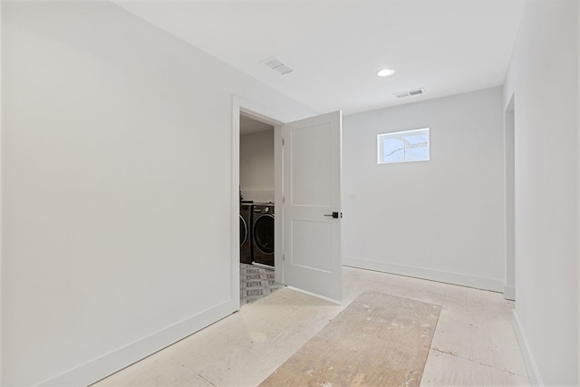 interior space featuring recessed lighting, baseboards, visible vents, and washing machine and clothes dryer