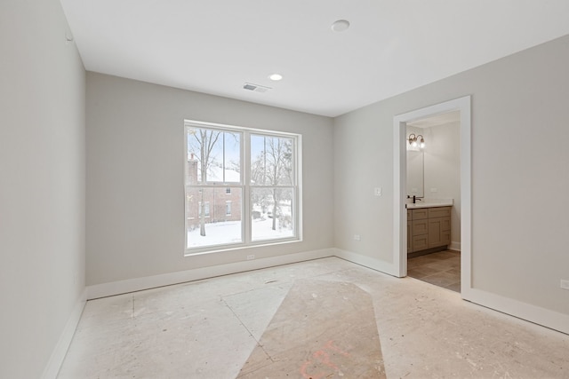 spare room with visible vents and baseboards