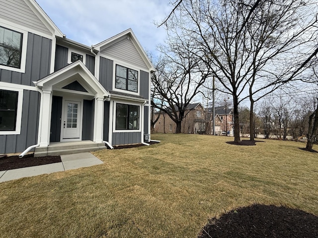 view of front of house featuring board and batten siding and a front yard