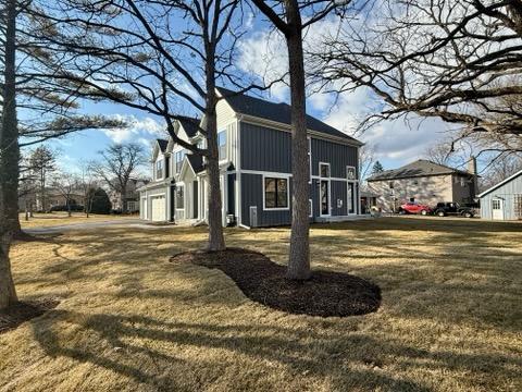 view of side of property with a lawn