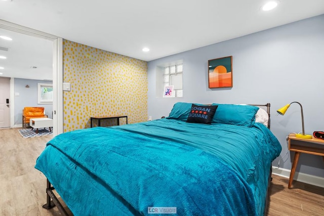 bedroom featuring baseboards, wood finished floors, and recessed lighting