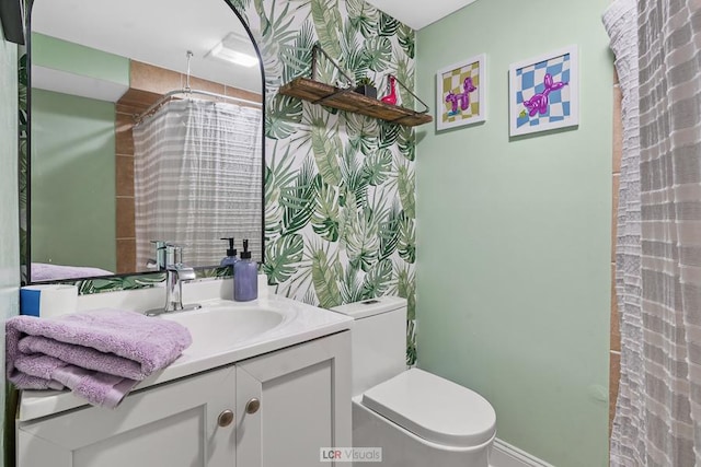 bathroom with toilet and vanity