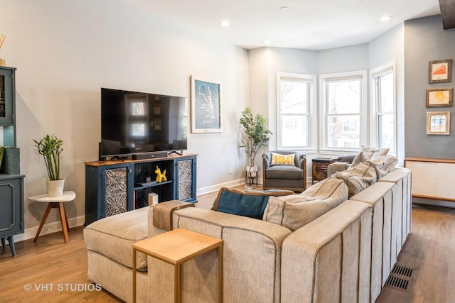 living room with recessed lighting, wood finished floors, visible vents, and baseboards