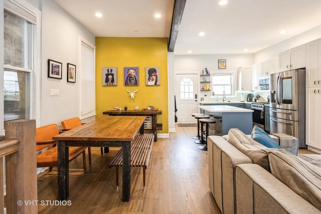 dining space featuring light wood-type flooring, baseboards, and recessed lighting