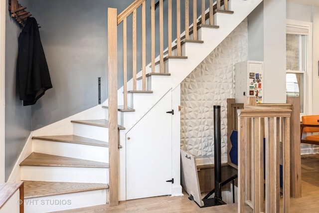 stairs featuring wood finished floors