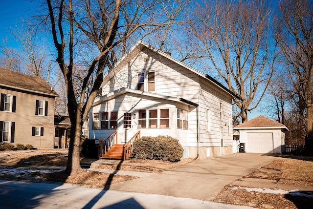 view of front of property featuring a garage, entry steps, an outdoor structure, and driveway