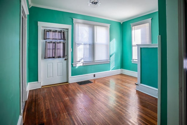 interior space featuring crown molding, baseboards, and dark wood-style flooring