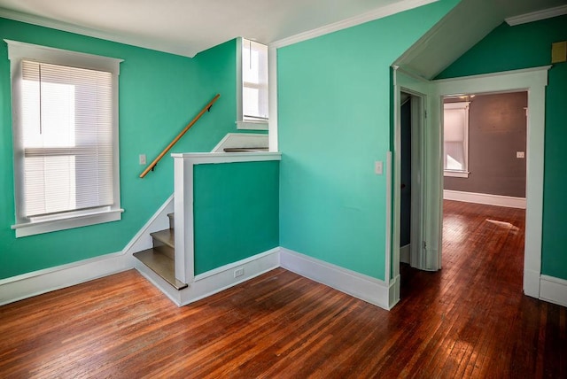 interior space with crown molding, baseboards, and wood finished floors