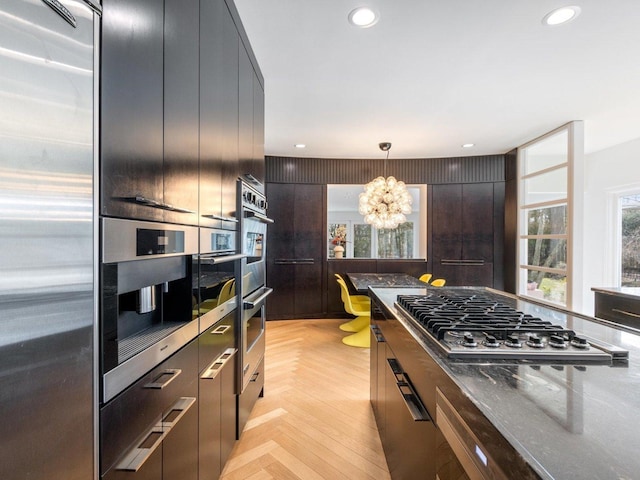 kitchen featuring recessed lighting, stainless steel appliances, modern cabinets, and an inviting chandelier