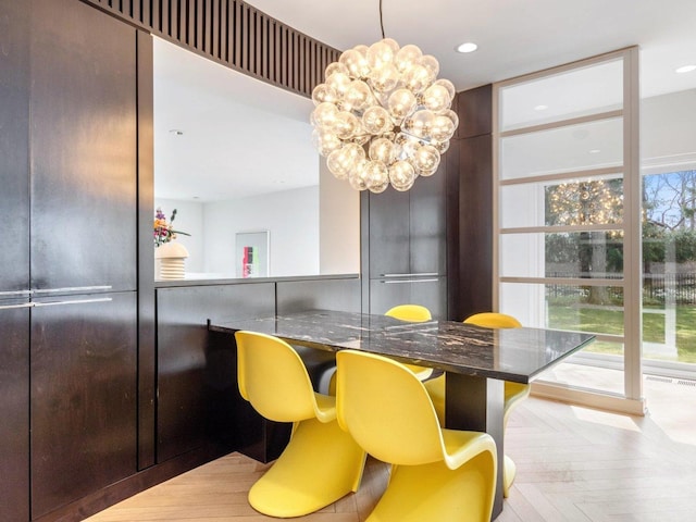 dining space with recessed lighting, a chandelier, and floor to ceiling windows