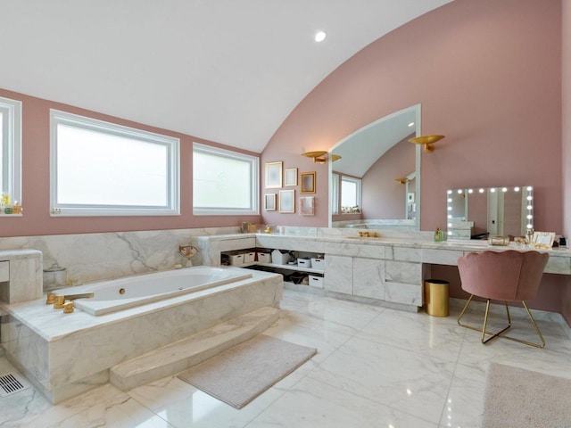 bathroom featuring a bath, marble finish floor, vanity, and vaulted ceiling