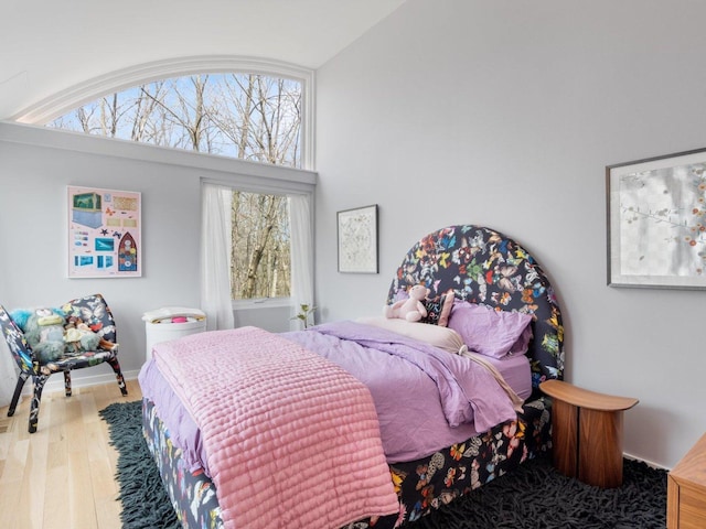 bedroom featuring multiple windows and wood finished floors