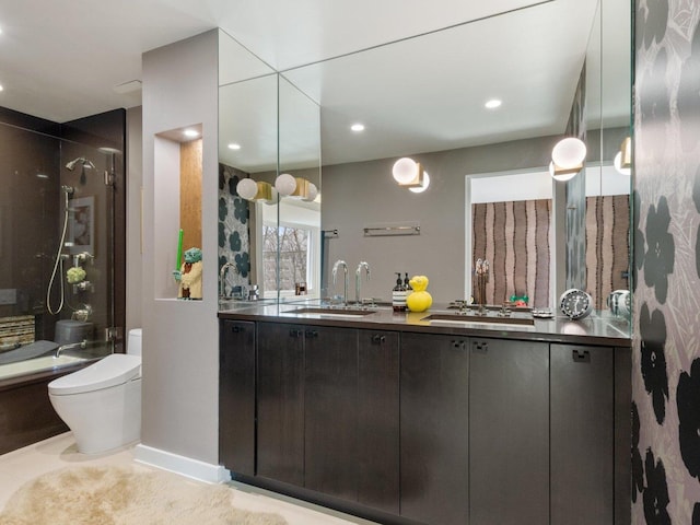 bathroom with double vanity, recessed lighting, a sink, a shower stall, and toilet