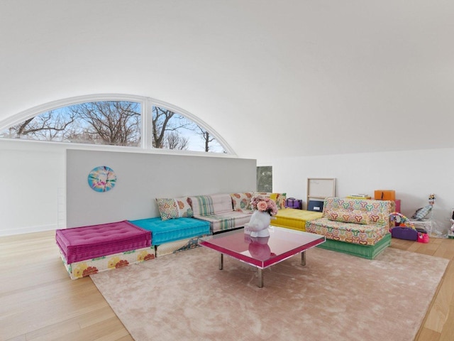 living area featuring lofted ceiling and wood finished floors