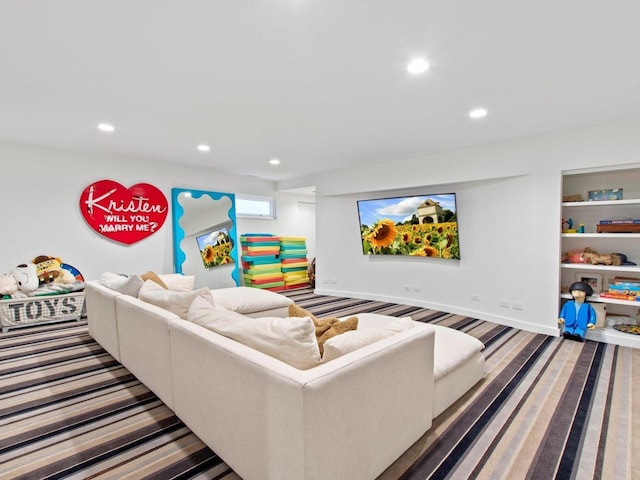 living area featuring built in shelves, recessed lighting, and baseboards