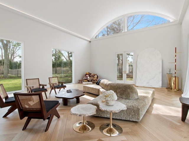 living area with french doors and high vaulted ceiling