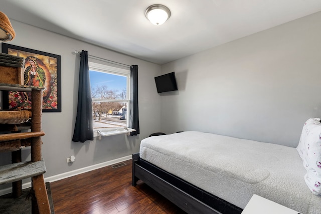 bedroom with visible vents, baseboards, and dark wood-style flooring