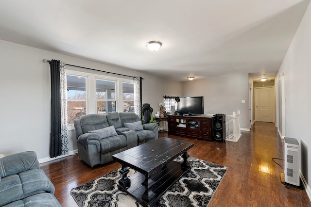 living room featuring baseboards and wood finished floors