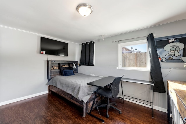 bedroom featuring baseboards and wood finished floors