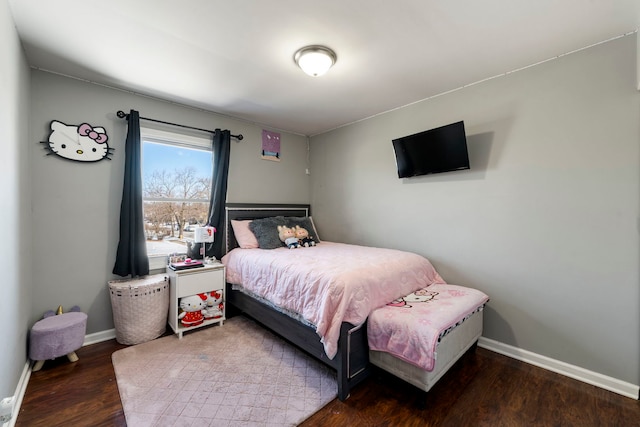 bedroom featuring baseboards and wood finished floors