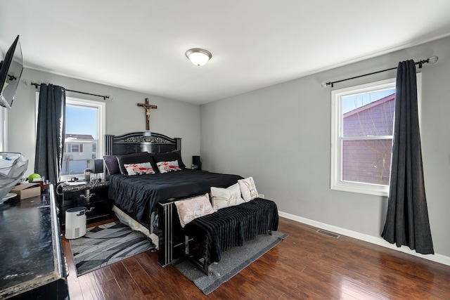 bedroom featuring visible vents, wood-type flooring, and baseboards