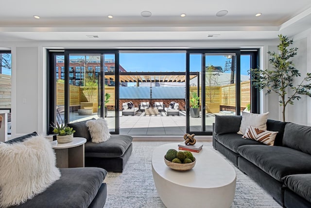 living area featuring visible vents and recessed lighting