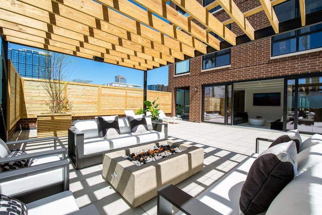 view of patio featuring an outdoor living space with a fire pit and fence