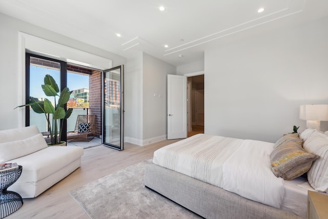 bedroom with baseboards, access to outside, light wood-style flooring, and recessed lighting