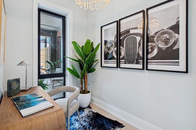 interior space featuring a chandelier and baseboards