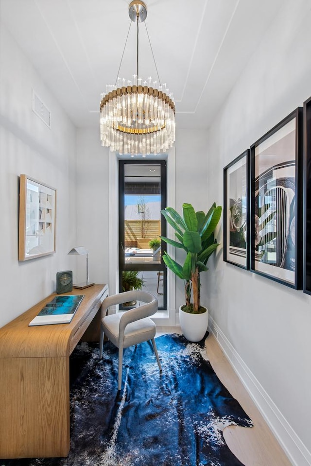 office area featuring an inviting chandelier, visible vents, and baseboards