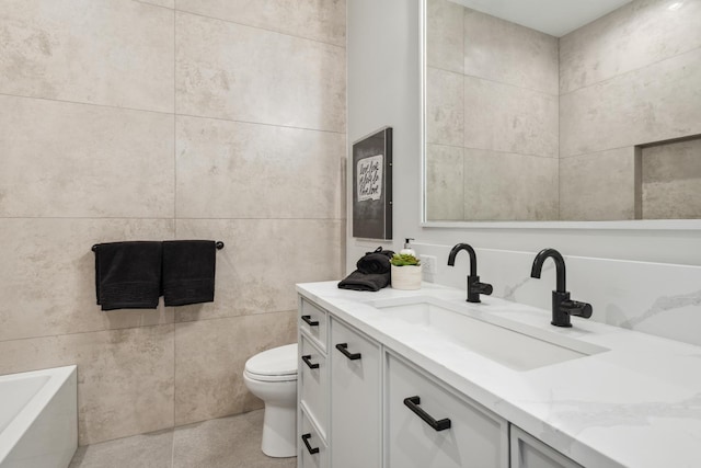 full bathroom with a washtub, toilet, tile walls, and vanity