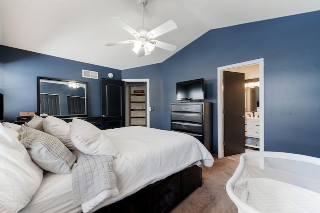 carpeted bedroom with visible vents, vaulted ceiling, a ceiling fan, and ensuite bathroom