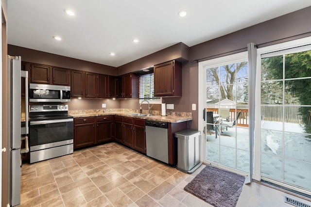 kitchen with appliances with stainless steel finishes, a sink, visible vents, and recessed lighting