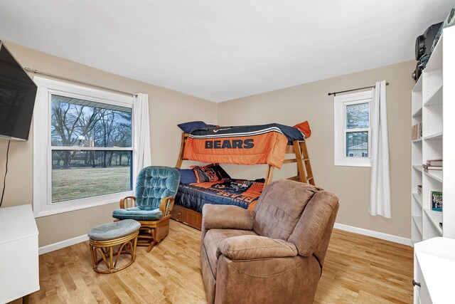 bedroom with light wood-type flooring and baseboards