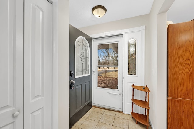 doorway to outside featuring light tile patterned floors