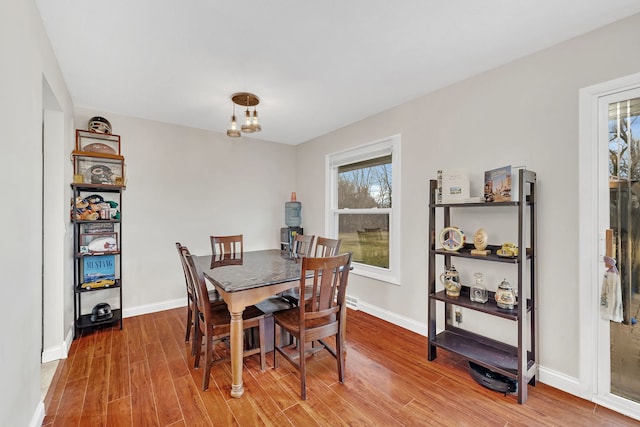 dining area featuring baseboards and wood finished floors