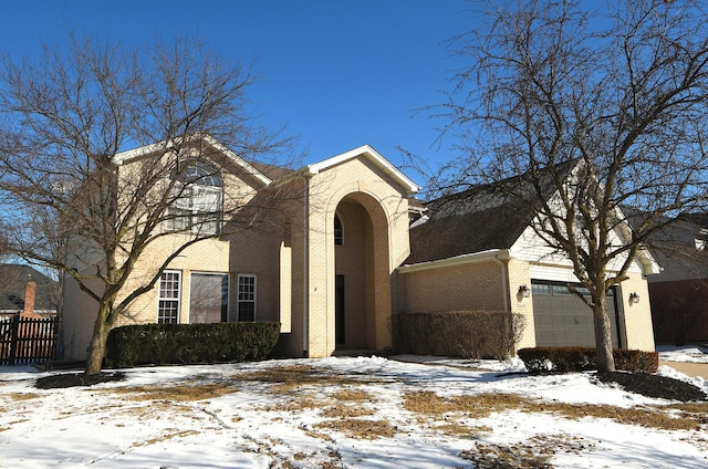 traditional-style house with brick siding and an attached garage