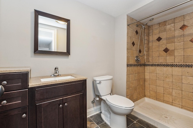 full bath with toilet, a shower stall, vanity, and baseboards