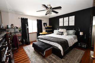 bedroom featuring a ceiling fan and wood finished floors