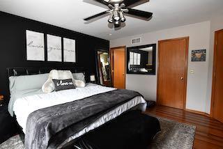 bedroom with a ceiling fan and wood finished floors
