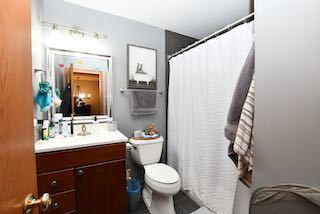 full bath featuring a shower with shower curtain, vanity, toilet, and tile patterned floors