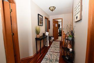 corridor featuring dark wood-style floors