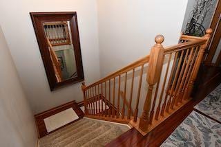 staircase with wood finished floors