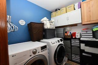 washroom featuring washing machine and dryer and cabinet space