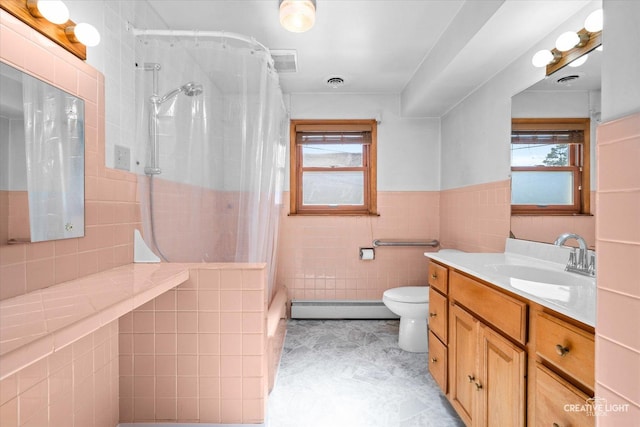 bathroom with a shower with shower curtain, tile walls, plenty of natural light, and baseboard heating