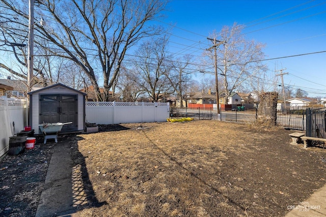 view of yard with an outbuilding, a storage shed, and a fenced backyard